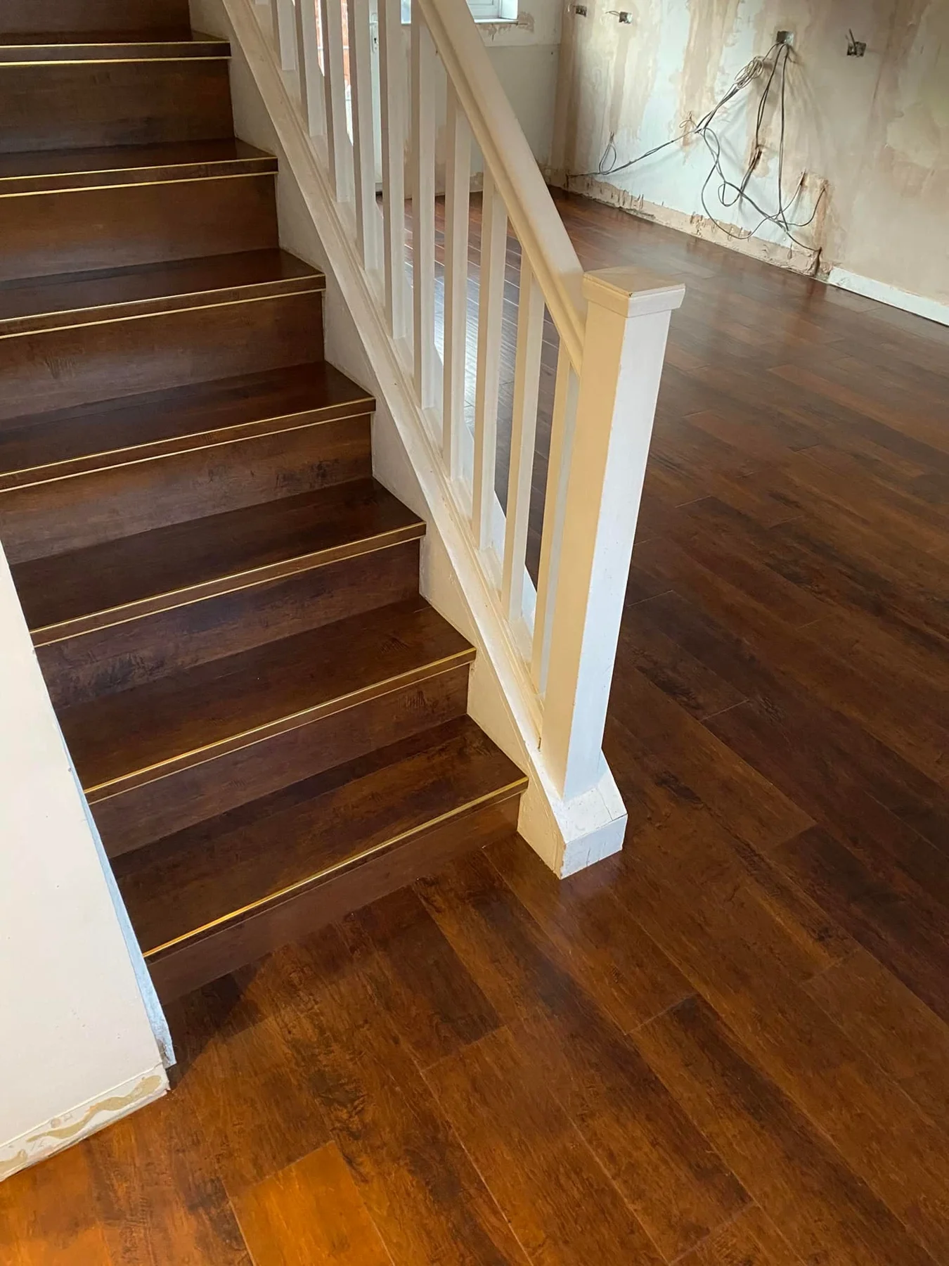 Wood-effect flooring on a staircase and adjoining hallway