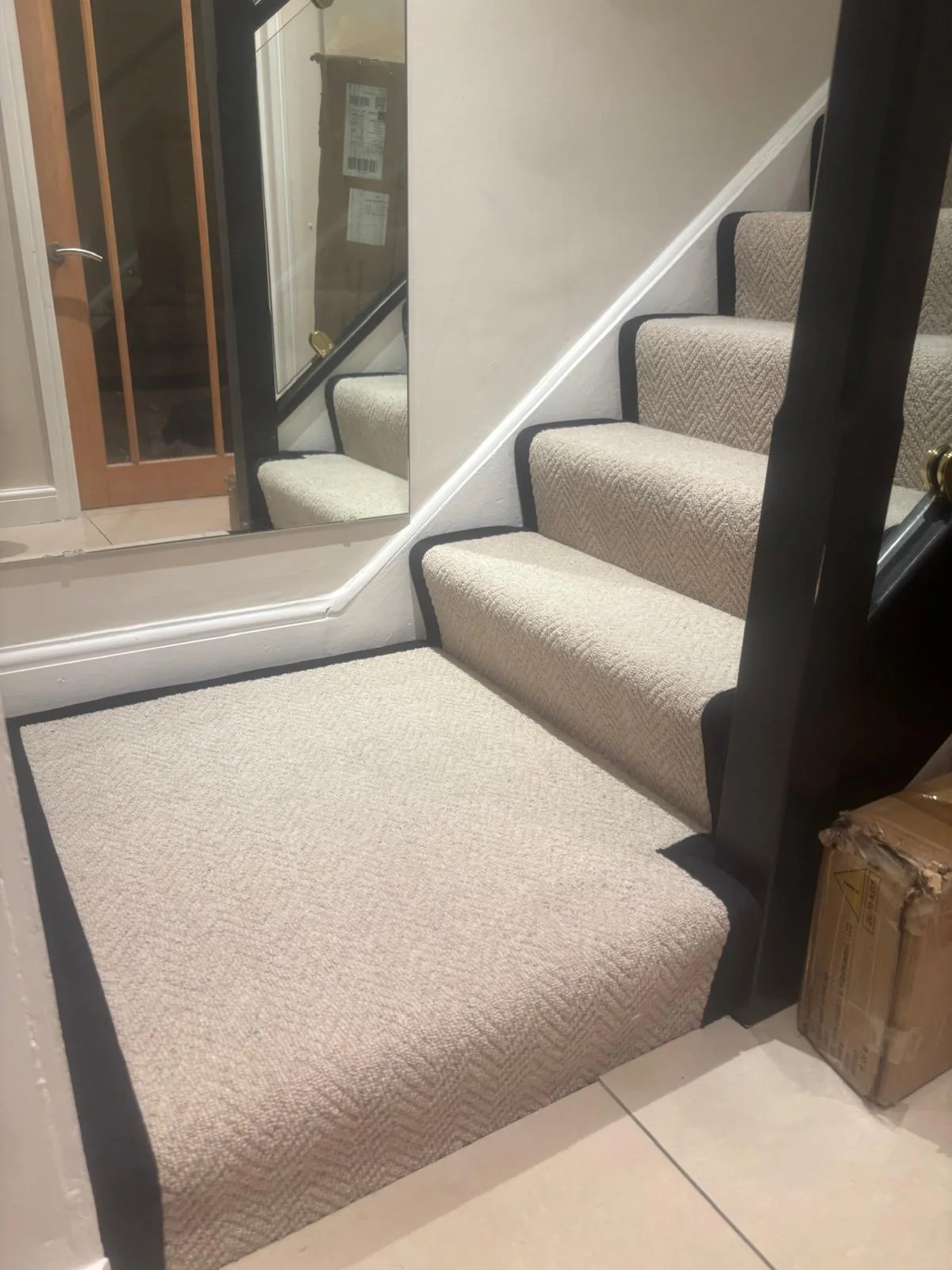 Bordered carpet fitted around a bottom step